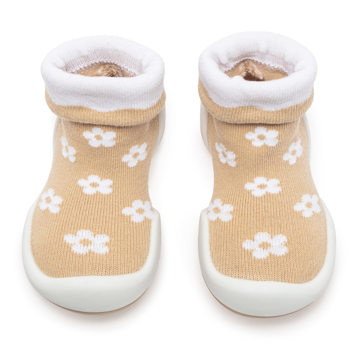 Two tan baby sock shoes with white floral pattern and white soles.
