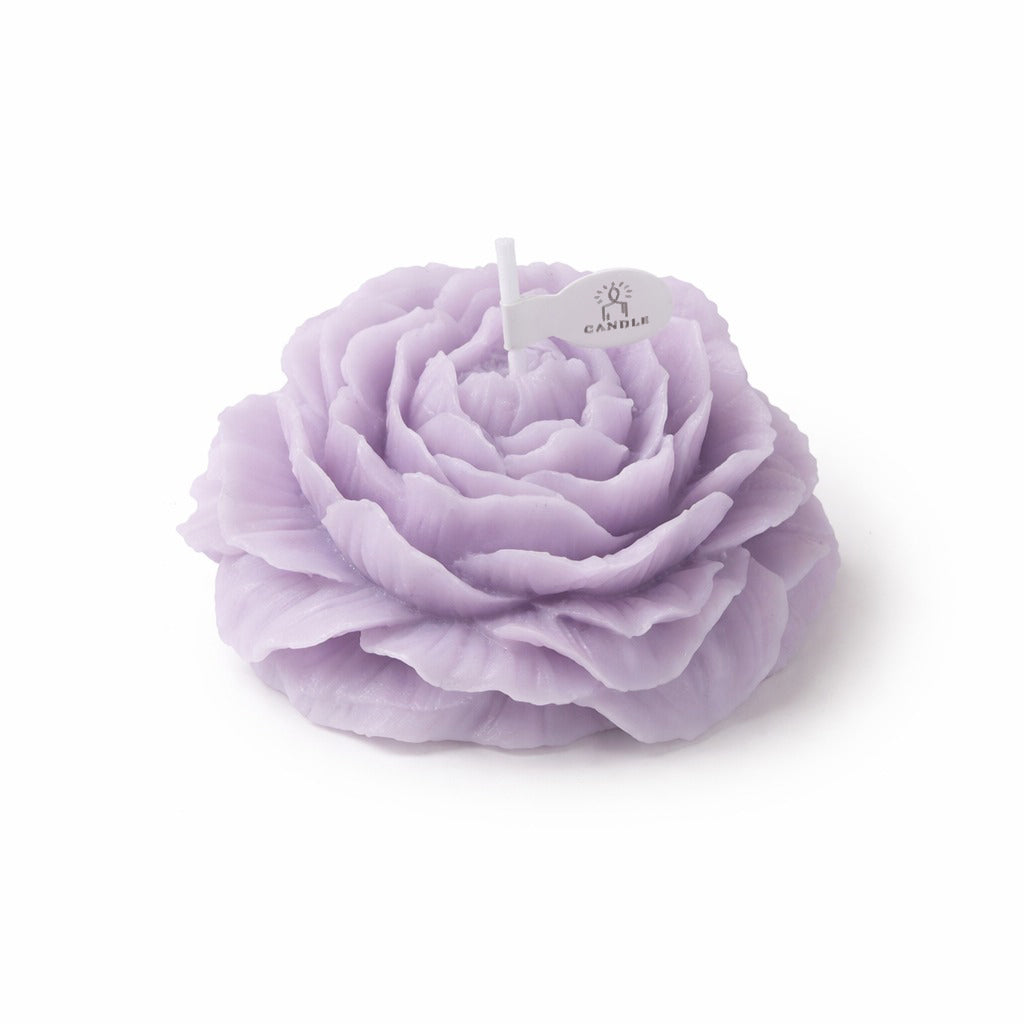Lavender peony candle by Jellycup, with a paper tag and a white wick.