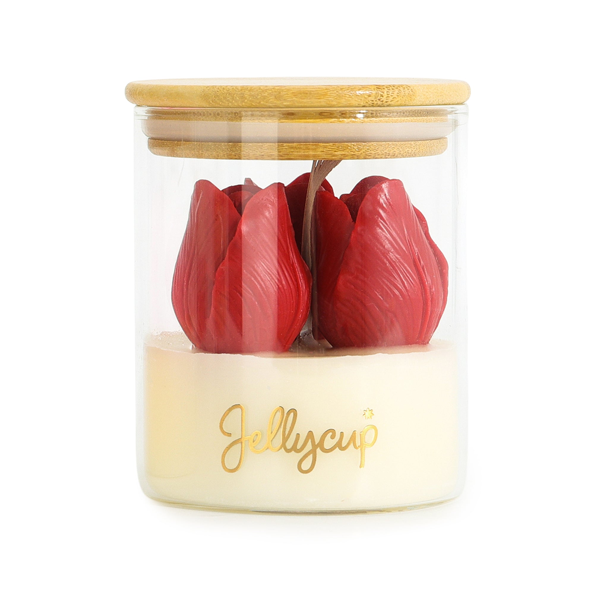A Jellycup jar candle with a clear glass body, a light wood lid, and a cream-colored wax base featuring two red tulip-shaped wax flowers and gold script branding.