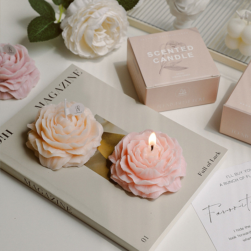 Peonie candle by Jellycup on a magazine with pink and peach color in a floral shape.