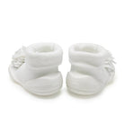 Two white baby sock-shoes with flower embellishments.
