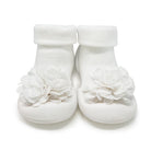 White baby shoes with flower embellishments.
