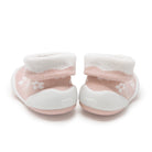 Two pink and white baby booties.
