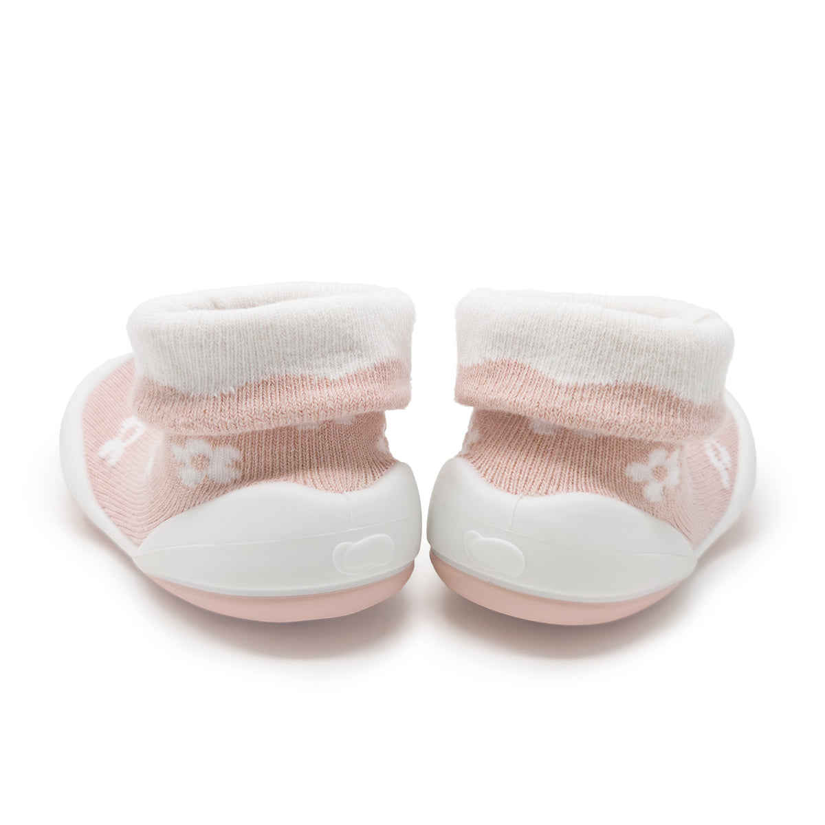 Two pink and white baby booties.
