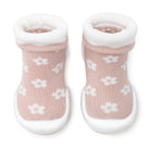 Pair of pink baby sock shoes with white flowers and soles.
