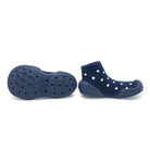 Navy blue socks with white polka dots and textured sole on a white background