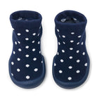 Pair of navy blue baby boots with white polka dots on a white background