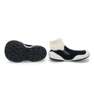 Black and white slip-on shoes with a textured sole on a white background