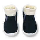 Pair of black pet boots with white soles and cream interior on a white background