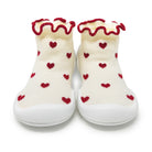 White socks with red hearts and ruffled edges on a white background