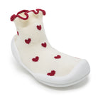 White sock with red heart patterns and white sole on a white background