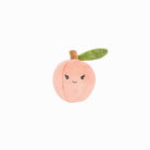 Plush toy shaped like a peach with a smiling face on a white background