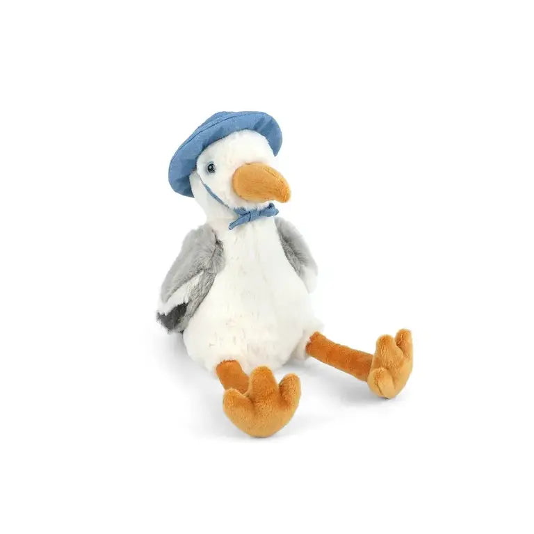 Plush toy penguin wearing a blue hat on a white background