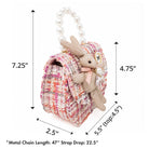 Pink tweed bag with a beaded handle and a bunny embellishment.