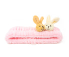 Pink fluffy headband with two bunny plushies.