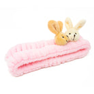 Pink, plush headband with two bunny heads.