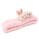 Pink plush headband with bunny and bear figures.