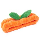 Orange plush headband with green leaves.
