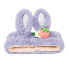 Purple, fuzzy headband with bunny ears and a strawberry.