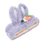 Lavender furry headband with bunny ears and a strawberry flower.