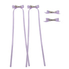 Lavender ribbon bow clip set featuring two clips with long trailing ribbons and two simple bow clips.