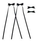 Four black ribbon bow clips, two with long trailing ribbons and two smaller solid bows.