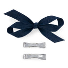Three-piece bow clip set with one large light denim bow and two smaller metallic silver bows on a white background.