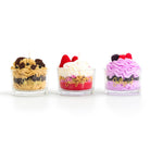 Three small dessert cups with different flavors on a white background, featuring the brand 'Jellycup'.