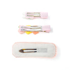 Three pink hair clips on a white background.