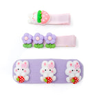 Three hair clips with cute cartoon decorations, on a white surface.