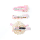 Three pastel-colored hair clips on white.