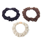 Three scrunchies in black, brown, and beige.