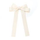 Ivory ribbon bow with long tails.