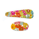 Two floral hair clips on a white background.