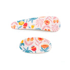 Two floral patterned hair clips.