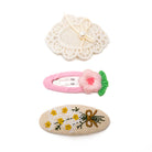 Three hair clips with floral patterns.