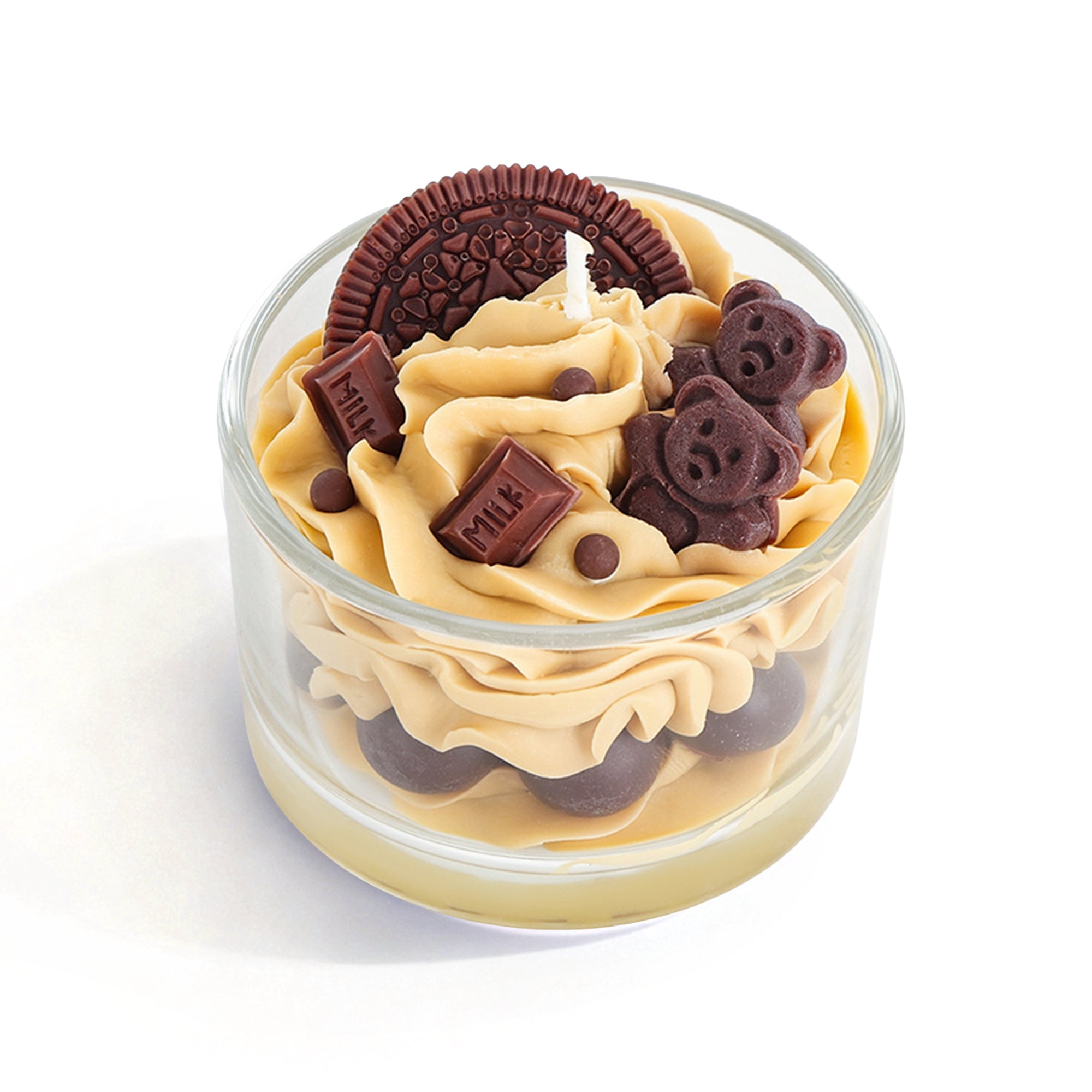 Candle in a glass container with peanut butter frosting and Oreo cookies on a white background