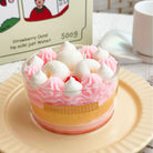 Pink and white dessert in a glass bowl on a beige plate with a blurred background