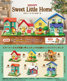 Model house set with Snoopy and Woodstock characters on a wooden surface, featuring colorful houses and small figures.