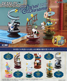 Snoopy Spiral Diorama set with various figures and scenes on a wooden surface.