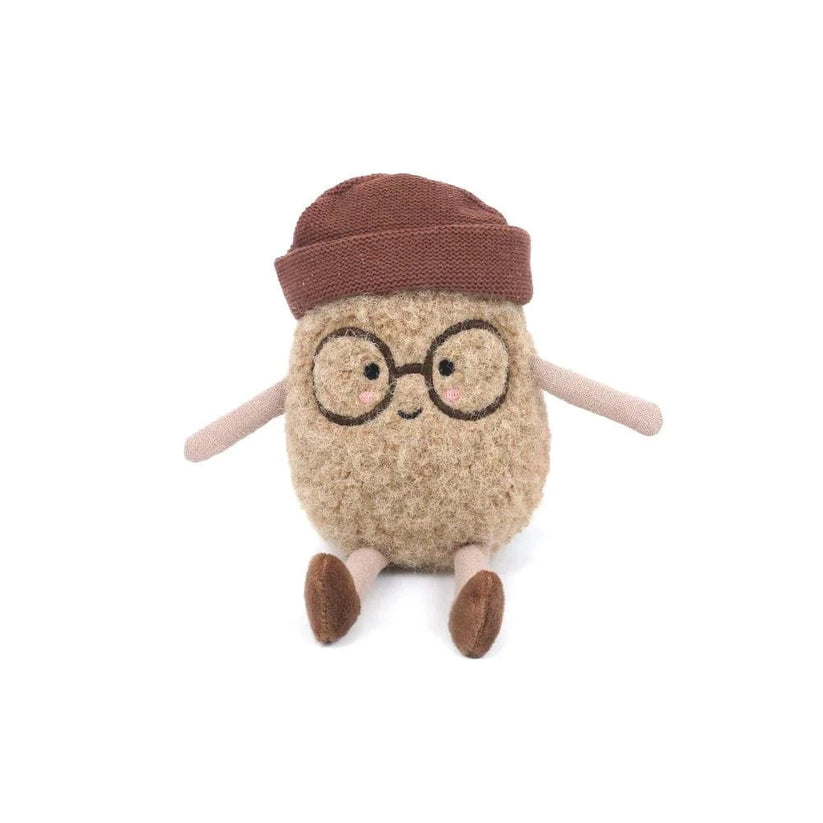 Stuffed brown toy bean with glasses and a hat sitting.