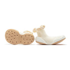 Two white sock-shoes with tan soles.